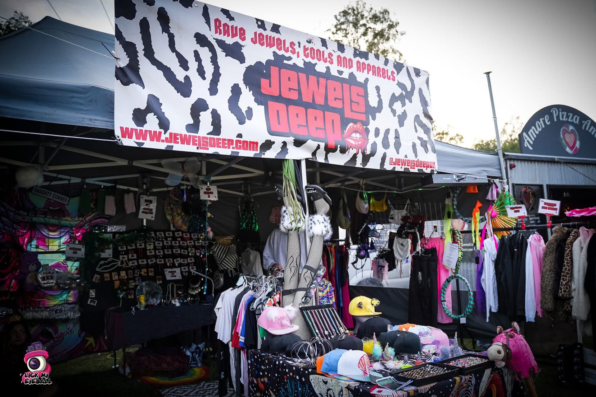 The Jewels Deep shop stall at a festival, with clothing, hats and jewellery